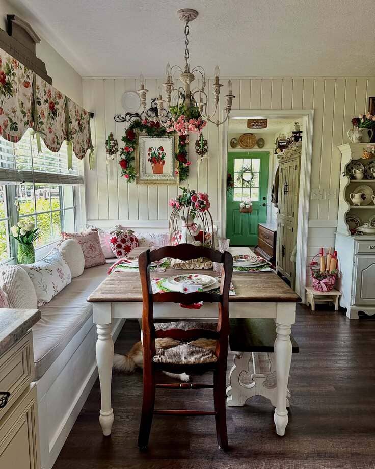 French country breakfast nook with floral decor and cozy bench seating