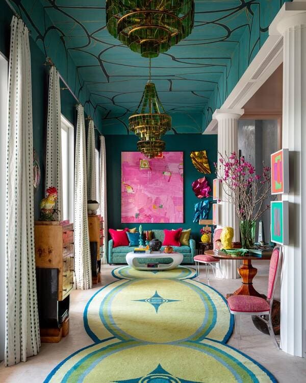 Bold maximalist living room with colorful art, vibrant furniture, and graphic ceiling
