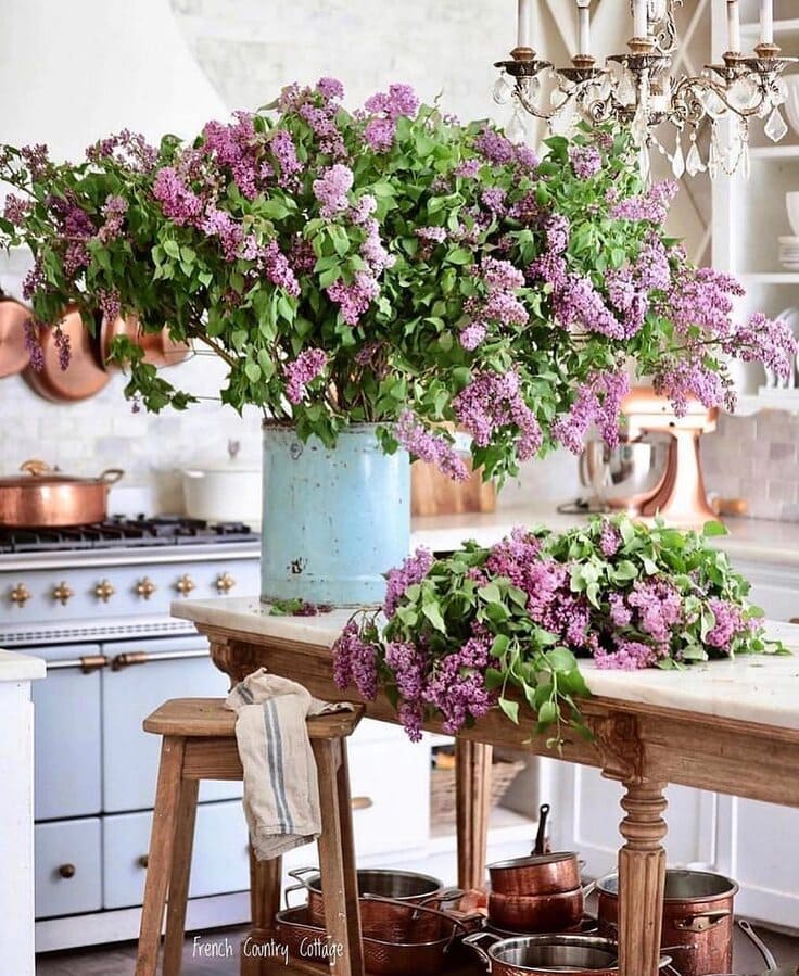 French country kitchen with lilac flowers and copper accents
