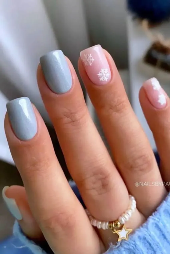 Soft pastel Christmas nail design with snowflakes on short nails