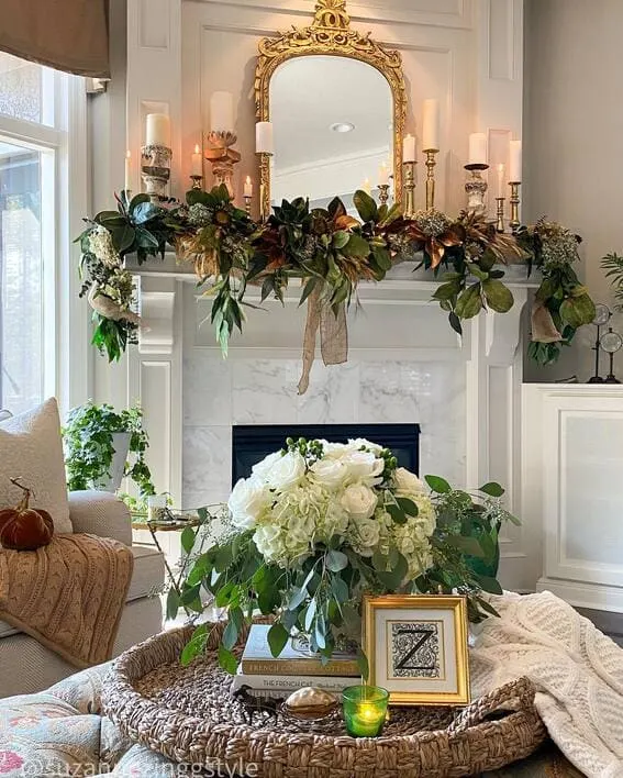 Sophisticated fall mantel with magnolia garland and candles.