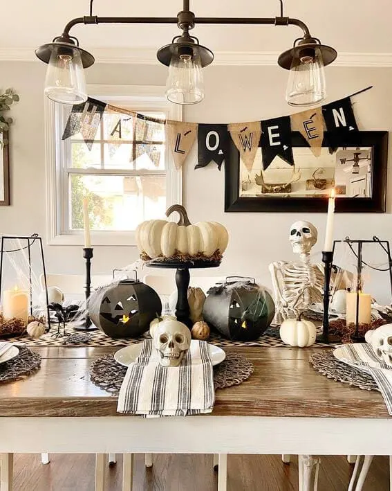 Festive Halloween dining table with spooky skeleton decor.