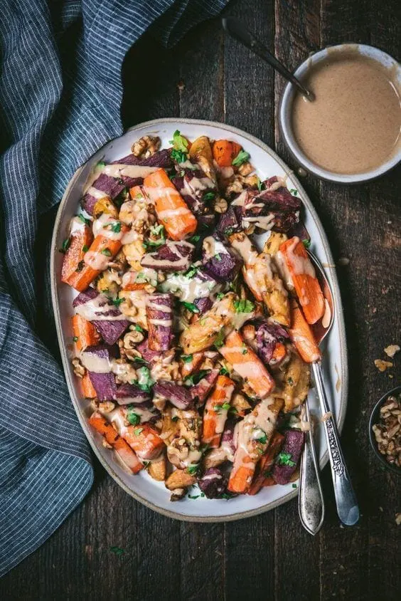 Roasted carrots, apples and sweet potatoes with cinnamon tahini drizzle via @everythingabode