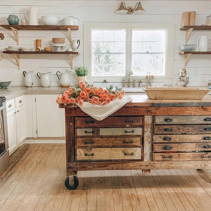 French country kitchen with rustic island and fresh flowers